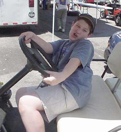 Jason was pretty sad that they ran out of golf carts on Saturday, so he had me out of bed at 6am on Sunday so we could get to the track to get one. Get one we did, and man, did it make it nice to get around! A good part of our day had us out in the expansive Bowling Green pits (well out of the way of the expensive and precious cars) with Jason driving around in circles. Ah, to be a kid again...