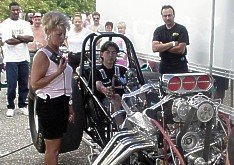 Bunny Burkett takes 14 year old Damian Moore through the controls on his funny car, 7-08-00. Photo by Tim Pratt