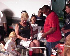 Bunny Burkett signs autographs before the final round. 7-08-00 by Tim Pratt