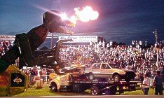 Transaurus approaches its dinner, a tasty Chevy Spectrum. 7 7-08-00 by Tim Pratt
