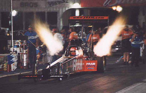 Rhonda Hartman lights up the night at NHRA Atlanta 2002. Photo by John Gulla