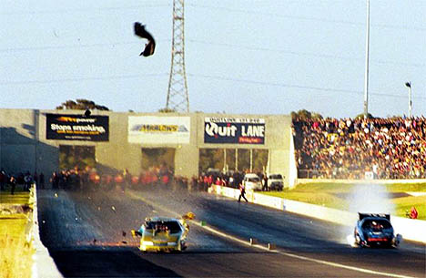 Allan Dobson is cranking at 275 mph when he blows the rear slick! Ashley Bailey is burning up a motor in the other lane. Photo by Jon Gall