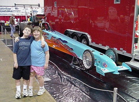 Lenny Cottrell puts on the Washington World of Wheels every year. Here are Jason and Emily in front of his Top Alcohol Dragster. Photo by Tim Pratt